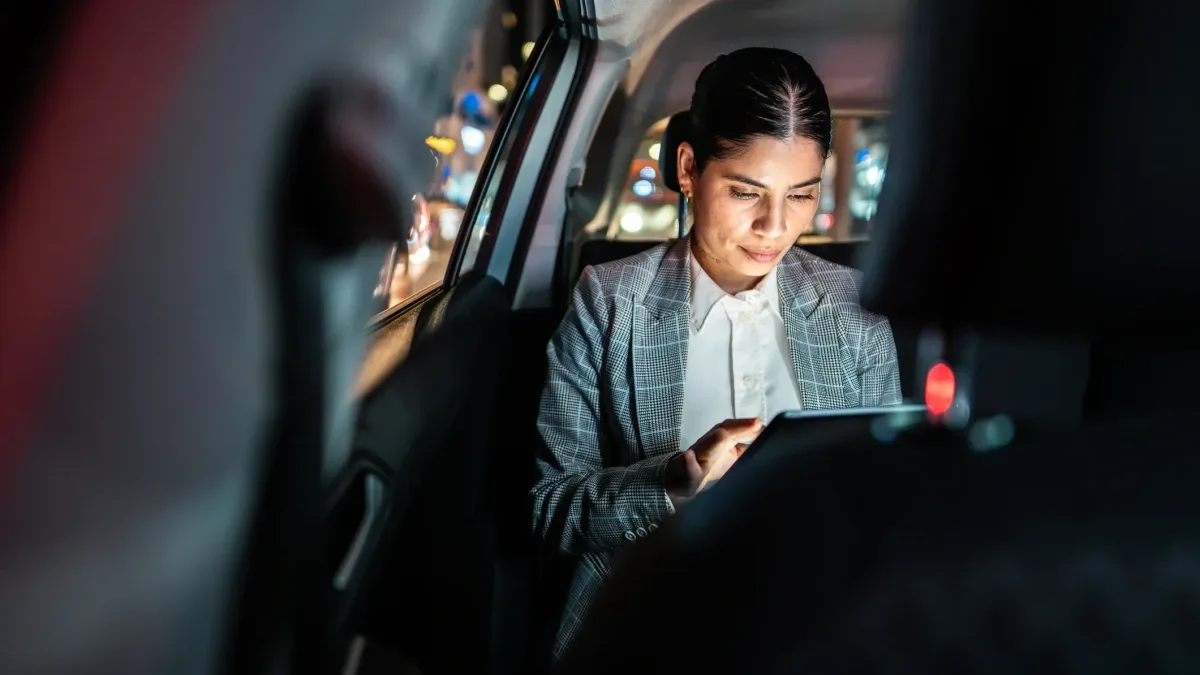 Passenger working in the rear cabin of a luxury SUV